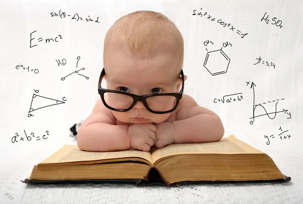 Little baby in glasses with eauations around — Stock Photo, Image