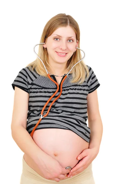 美しい妊娠中の女性彼女の赤ちゃんの心臓の鼓動に耳を傾け ロイヤリティフリーのストック写真