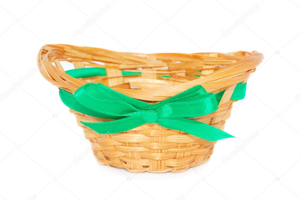 empty straw basket with a green ribbon and a bow 