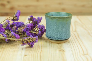 Vintage çay bardağı ve ahşap arka plan üzerinde kuru çiçek