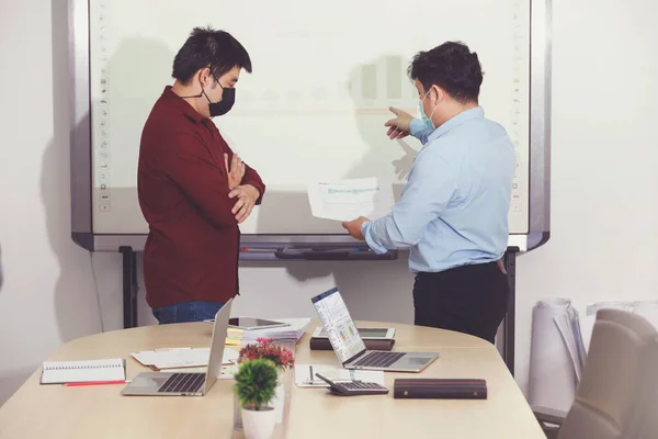 New normal and Social distance conceptual, Employee wearing medical facial mask working in office.