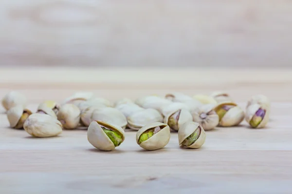 Close up pistachios on wooden background, — Stock Photo, Image