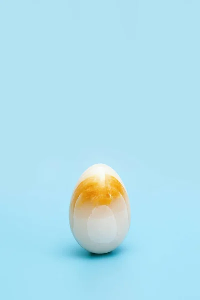 Yellow stone texture Easter egg. Minimal style composition, Spring celebration concept.