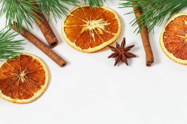 Kurutulmuş portakal dilimleri ve arkaplanda tarçın çubukları. Sıcak şarap için baharat. Yeni yıl için arkaplan.