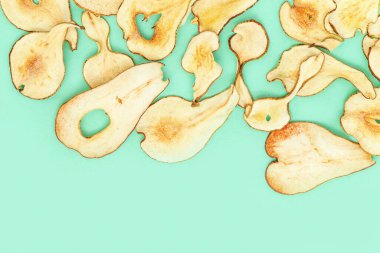 Bitki bazlı gıda geçmişi. Susuz kalmış armut cipsi, sağlıklı atıştırmalık ya da tatlı olarak dilimler. Üst görünüm ve kopyalama alanı.