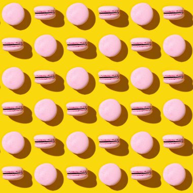 Seamless regular creative pattern of colorful french cookies macarons. Printing on fabric, wrapping paper.