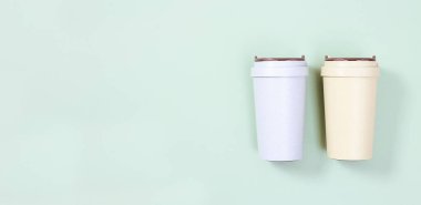 Reusable eco coffee cup. Zero waste concept, flat lay. Ban single use plastic. Take away big mug for drinks. Bammer with copy space.