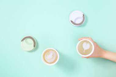 Take away coffee cappuccino and latte art in Reusable eco thermo mug. Shopping at coffee shop. Social media content.