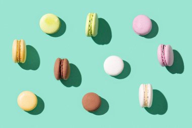 Parlak mavi renkli arka planda çeşitli badem kurabiyeleri renkli Fransız kurabiyeleri. Sabit ışık ve kopyalama alanı.