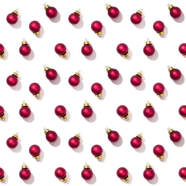 白の背景に隔離された明るい光沢のある小さな赤いクリスマスボールとシームレスな定期的な創造的なパターン 布に印刷 包装紙 — ストック写真