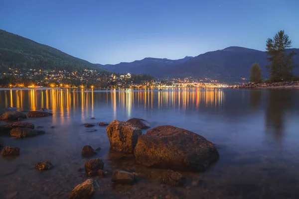 The town lights of Nelson, B.C. on Kootenay Lake taken on a summer\'s evening from the north shore.
