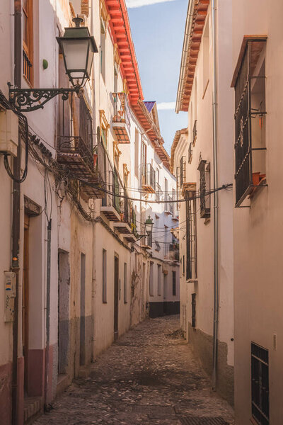 Quiet and quaint narrow cobblestone streets in old town (Albaicin or Arab Quarter) Granada, Spain, Andalusia.