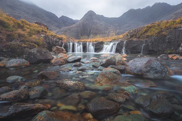 Moody, dramatic mountain and waterfall landscape of the Fairy Pools and Black Cuillins at Glen Brittle on the Isle of Skye in the Scottish Highlands, Scotland.