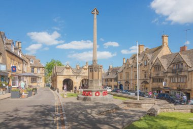 Chipping Campden, UK - June 12 2021: The historic main square with wwi war memorial and old town market hall in the quaint English village of Chipping Campden, Gloucestershire, England. clipart