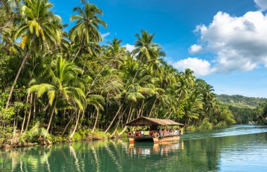 traditional raft boat with tourists at Bohol island clipart