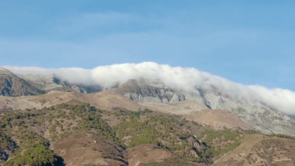 Timelapse Billowing Clouds Rolling Top Mountain — Vídeos de Stock