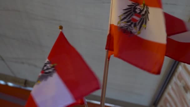 Slow Motion Two Small Austrian Flags Waving Front Souvenir Shop — Stock Video