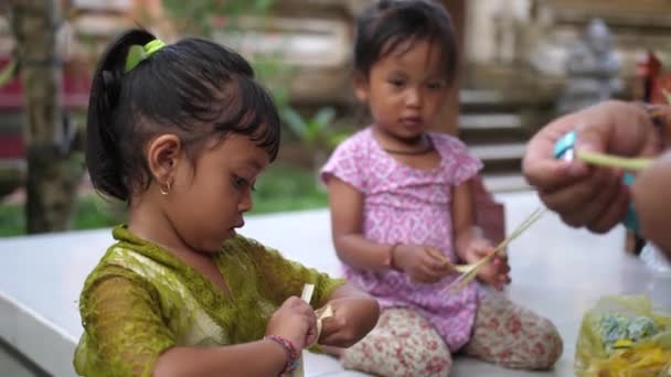 巴厘岛的幼儿帮助妈妈做印度教的祭品 作为她们家务活的一部分 孩子们在很小的时候就学会了工作 印度尼西亚 文化和宗教 — 图库视频影像