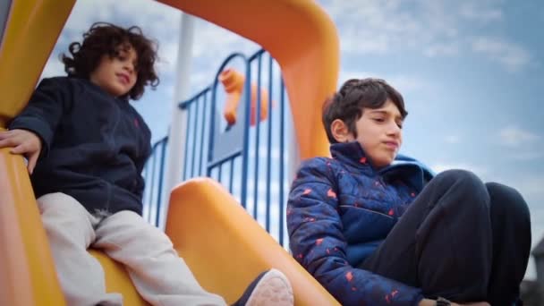 Two Kids Sliding Slide Park Slow Motion — Stock Video