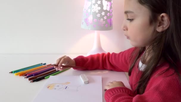 Een Jong Meisje Zittend Aan Een Tafeltekening Met Gekleurde Potloden — Stockvideo