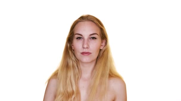 Atraktivní blondýny model udeří různé pózy na bílém pozadí studia