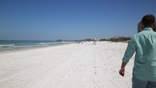 Man Walking White Sand Beach Enjoying Sunny Day — Stock Video