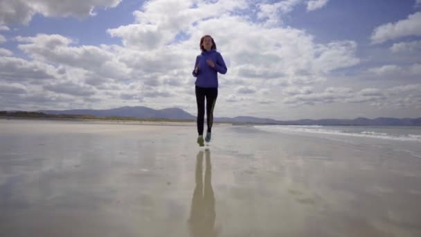 Low Dolly Shot Girl Running Jogging Shore Sandy Beach Atlantic — Stock Video