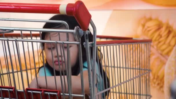 Young Girl Sitting Shopping Cart Store Alone — Stock Video