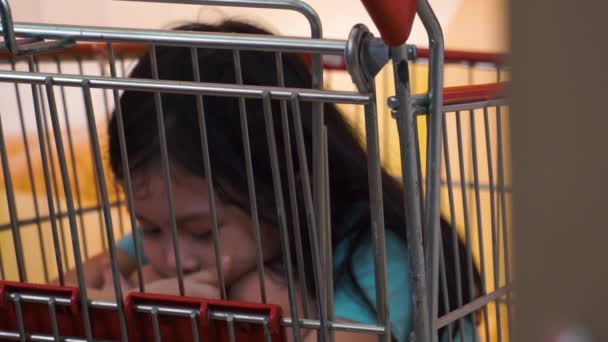 Young Girl Sitting Shopping Cart Store Alone Close Sleeping Napping — Stock Video