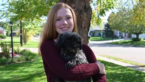 Madelyne Smiles While Holding Her Loving Dog Gentle Wind Blows — Stock Video