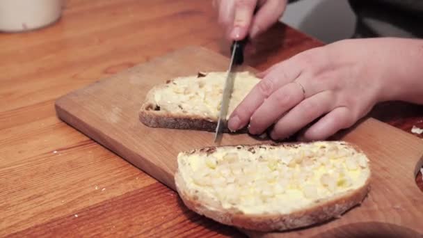 Dłonie Kobiety Kroją Dwa Kawałki Chleba Masłem Czosnkiem Preparaty Robienia — Wideo stockowe
