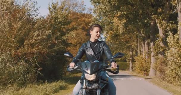 Mujer Joven Europea Bastante Sonriente Conduciendo Una Moto Con Chaqueta — Vídeos de Stock