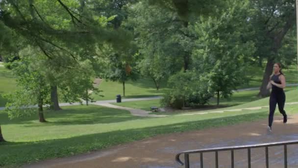 Woman Running Park Runs Stairs Camera Camera Pans See Her — Stock Video