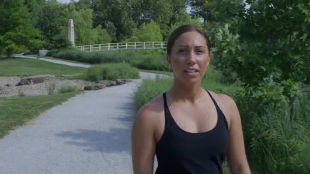 Female Runner Enjoys Cool Running Path Forest Park Bridge Background — Stock Video