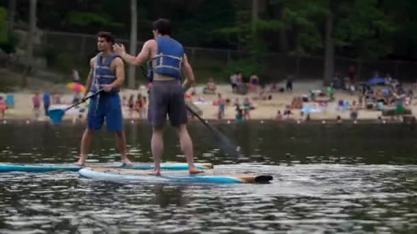 Two Boys Paddling Lake Paddle Boards — Stock Video