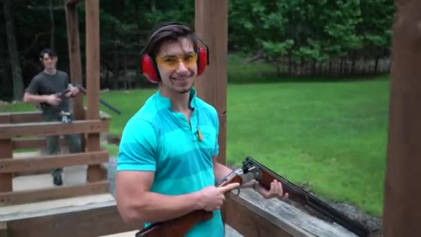 Young Man Smiling Getting Thumbs Friends Shooting Clay Wobble — Stock Video