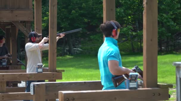 Wide Shot Three Separate Shooting Stations Middle One Aims Fires — Stock Video