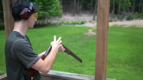 Young Man Wearing Ear Protection Putting Cartridge His Gun Cocking — Stock Video