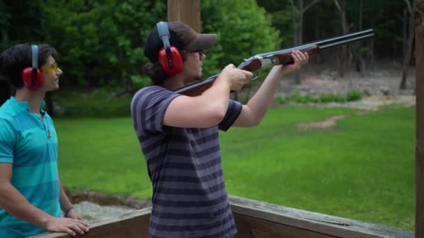 Closeup Young Man Loading Cartridge His Gun Aiming Firing Laughing — Stock Video