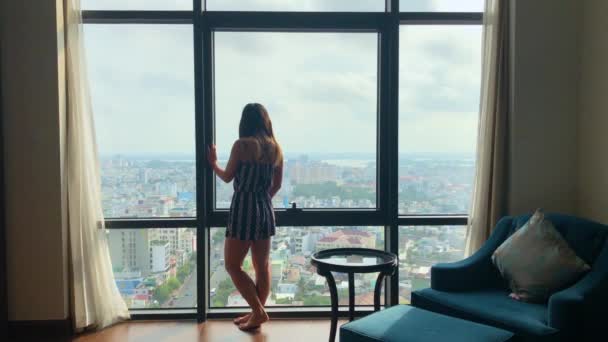 Beautiful Woman Looks Out Her Hotel Room Window While Vacation — Stock Video