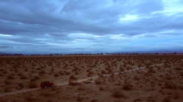 Antenn Roterande Pan Röd Jeep Kör Genom Mojaveöknen Före Kväll — Stockvideo