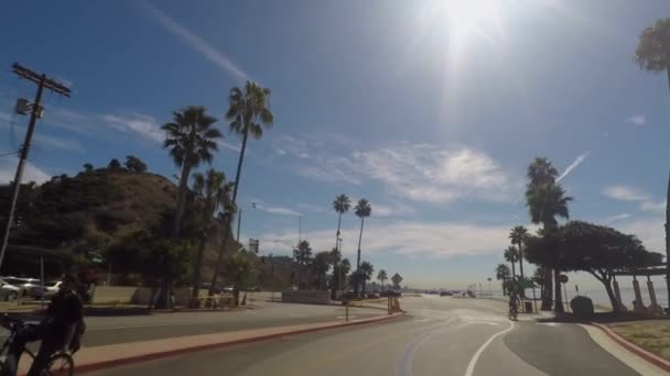 Pov Driving California Beach Street Palm Trees People Riding Bikes — стоковое видео