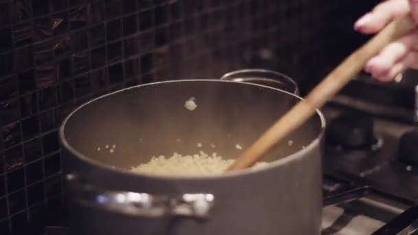 Una Mano Femenina Revolviendo Una Olla Arroz Caliente Con Una — Vídeos de Stock