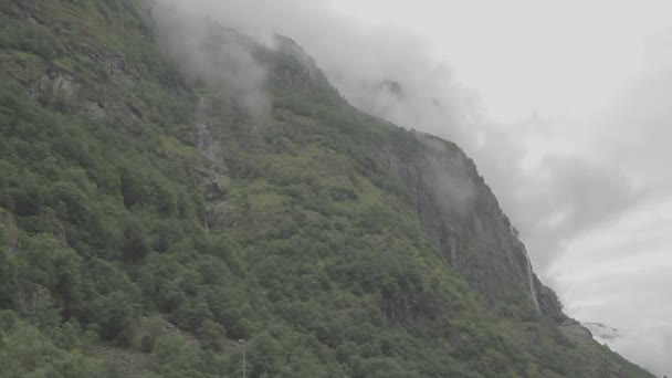 美しいフィヨルドノルウェー 霧の丘と小さな滝 トラッキングショット — ストック動画