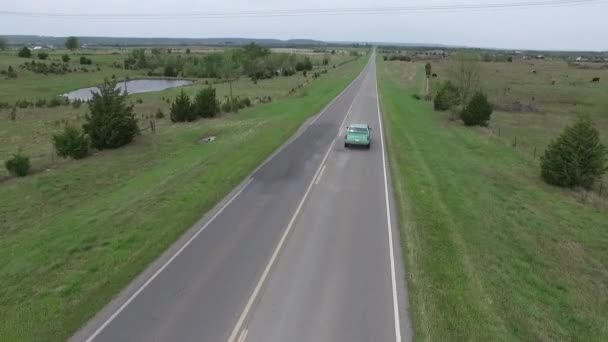 Aerial Chase Shot Green 1988 Oldsmobile Cutlass Rural Two Lane — Vídeo de stock