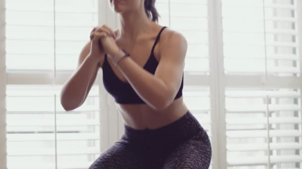 Brunette Woman Does Squats Sports Bra Tights Bright Studio — Stock Video