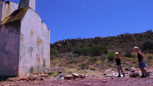 Two Little Boys Throw Eggs Old Farmhouse Wall Blue Sky — Stock Video