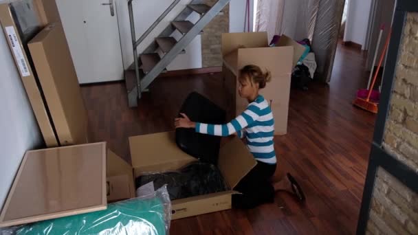 Asian Girl Unpacks Cardboard Box Looks Its Contents Contents Pieces — Stock Video