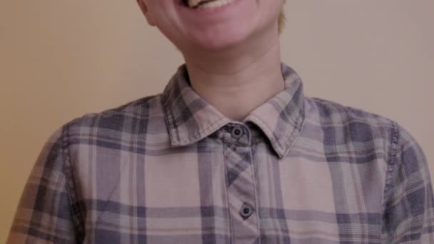 A person giggling and laughing in front of the camera.