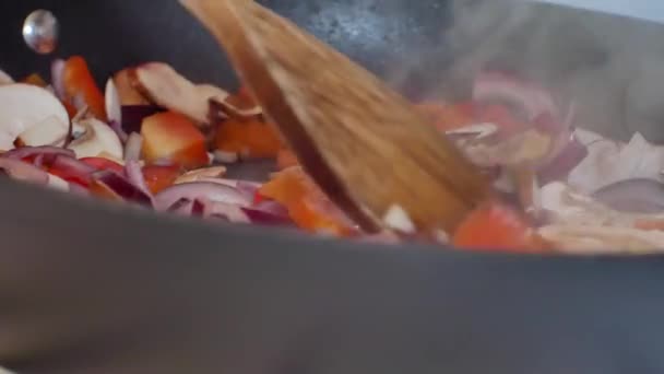 Close up on hot pan filled with nutritious fresh vegetables in preparation cooking meal in home kitchen. Hot, steaming stove top pan.